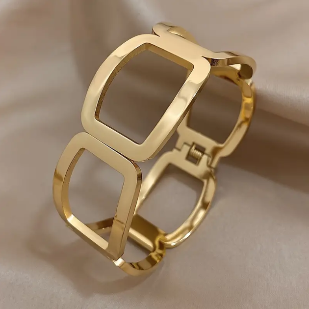 Elevate your style with Mozzimo Jewelry's Gold Plated Geometric Cutout Oversize Bangle Bracelet, a bold statement accessory for modern fashion lovers.