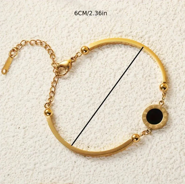 Elevate your wrist game with this Gold Plated Black Enamel Circle Pendant Thin Bangle Bracelet—a chic and sophisticated jewelry piece.
