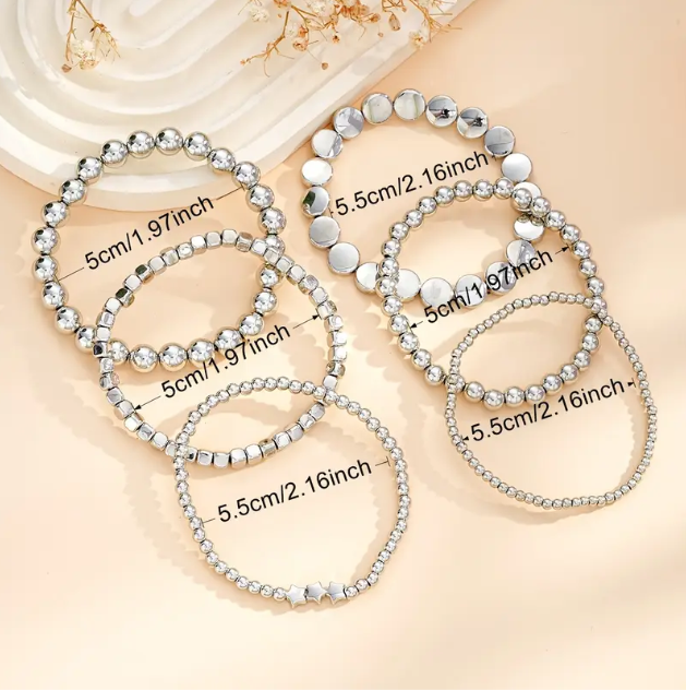 Elevate your stack game with this 6-piece sterling silver beaded bracelet set featuring stars, circles, and squares.