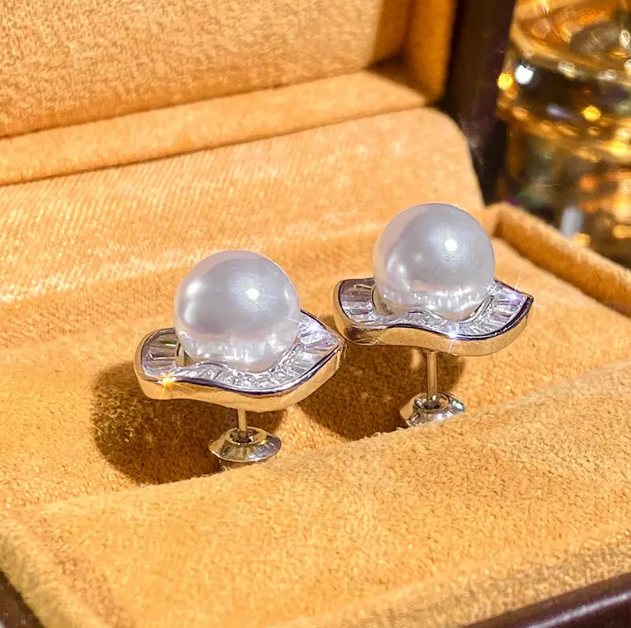 Elevate your style with Sterling Silver Large Circle Faux Pearl Stud Earrings, a modern and elegant statement piece—available now at Mozzimo Jewelry.