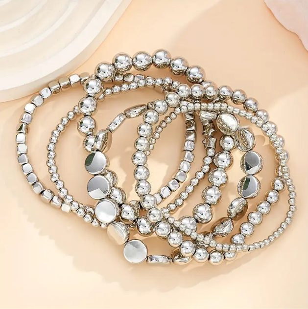 Elevate your stack game with this 6-piece sterling silver beaded bracelet set featuring stars, circles, and squares.