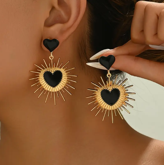 Make a bold fashion statement with Mozzimo Jewelry’s Gold Plated Sunburst Black Heart Dangle Earrings.