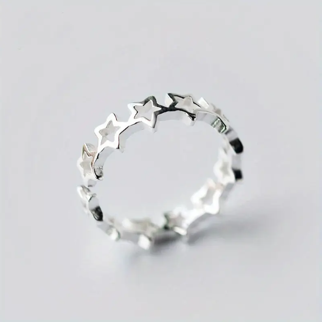 Shine like the stars with this Sterling Silver Thin Connected Cutout Stars Adjustable Ring – a trendy, celestial-inspired statement piece.