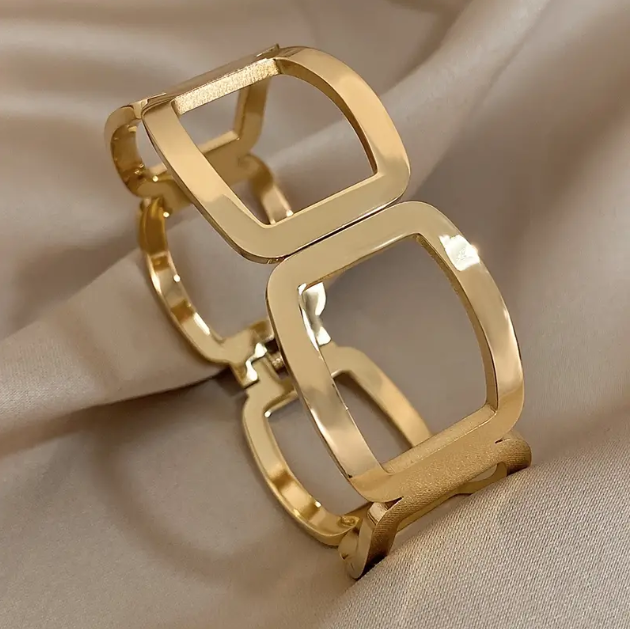 Elevate your style with Mozzimo Jewelry's Gold Plated Geometric Cutout Oversize Bangle Bracelet, a bold statement accessory for modern fashion lovers.