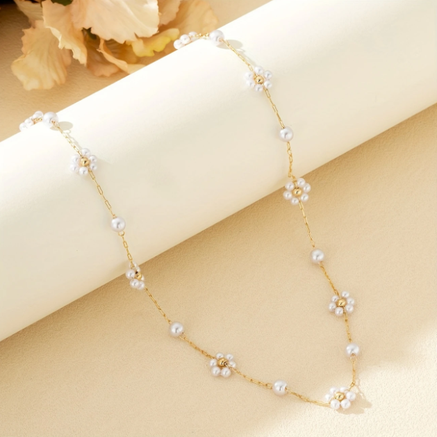 Elegant and dainty, this gold-plated necklace features mini faux pearl flower charms on a fine chain—perfect for layering or solo wear.