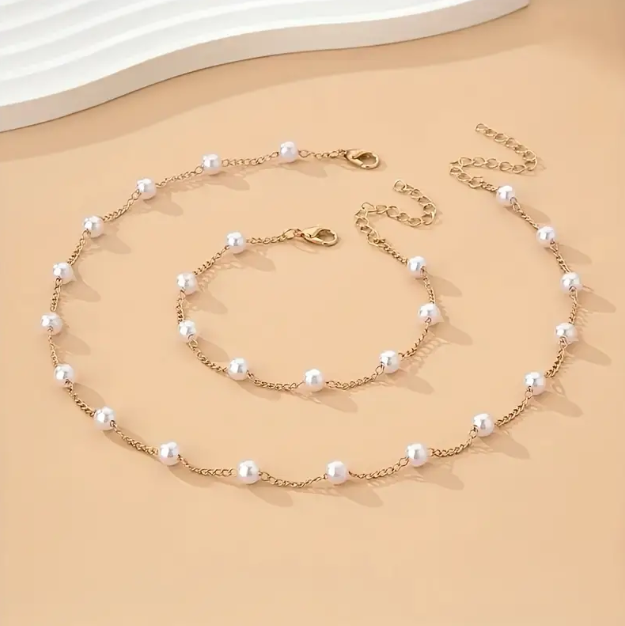 Add a touch of classic elegance with this gold-plated faux pearl choker necklace and bracelet set, perfect for effortless sophistication.