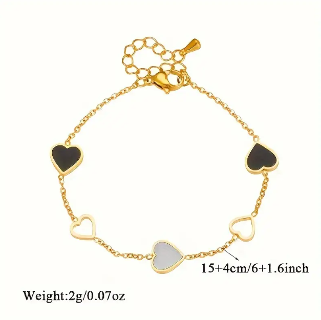 Dainty and elegant, this gold-plated black and white enamel heart charm bracelet is perfect for everyday wear or as a gift.