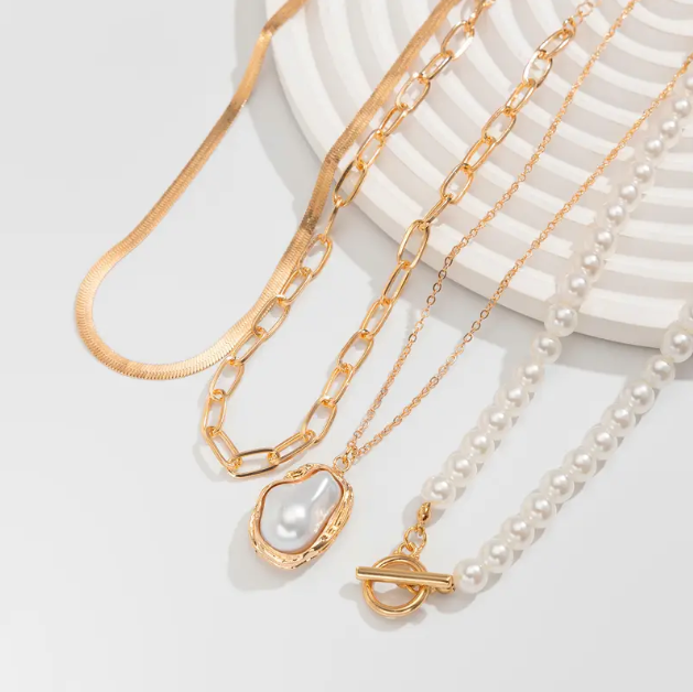 Stunning gold plated triple layer necklace with pearls and bold pendant β the ultimate layering piece for modern elegance and timeless charm.