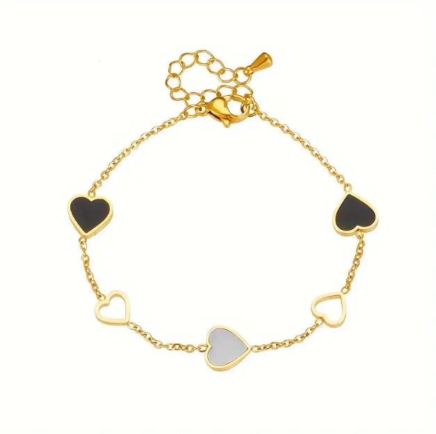 Dainty and elegant, this gold-plated black and white enamel heart charm bracelet is perfect for everyday wear or as a gift.