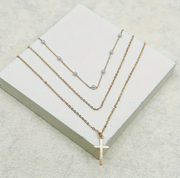 Stylish Multi-layer Gold Plated Chain Necklace with Imitation Pearls and a Cross Pendant – a perfect blend of elegance and modern faith-inspired jewelry trends.