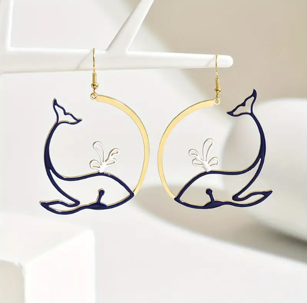 Discover Mozzimo Jewelry’s Gold Plated Blue Whale Ocean Waves Artistic Earrings—stunning marine-inspired enamel earrings with a gold finish—available now at www.mozzimojewelry.com.