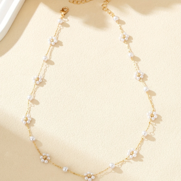 Elegant and dainty, this gold-plated necklace features mini faux pearl flower charms on a fine chain—perfect for layering or solo wear.