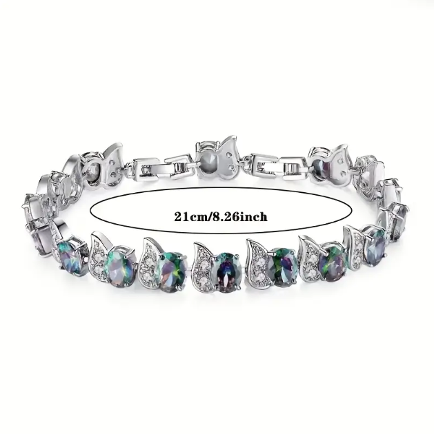 Elevate your style with the Sterling Silver Green Gemstone Cubic Zirconia Adjustable Bracelet, a dazzling and timeless accessory—available now at Mozzimo Jewelry.