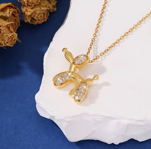 Add charm to your style with our Iconic Gold Plated Gem Encrusted Balloon Dog Charm Necklace—shop this fun and fashionable piece at Mozzimo Jewelry today!