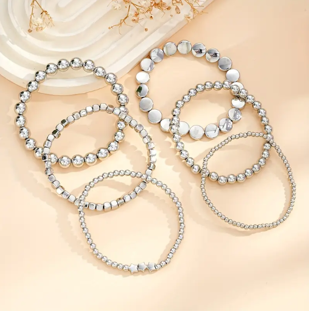 Elevate your stack game with this 6-piece sterling silver beaded bracelet set featuring stars, circles, and squares.