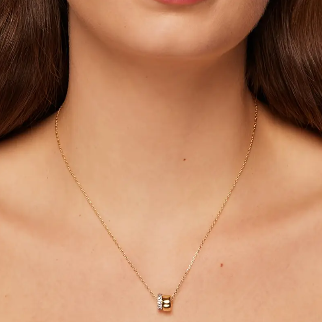 Add sparkle to your everyday look with our gold plated rhinestone encrusted mini rings pendant charm necklace.