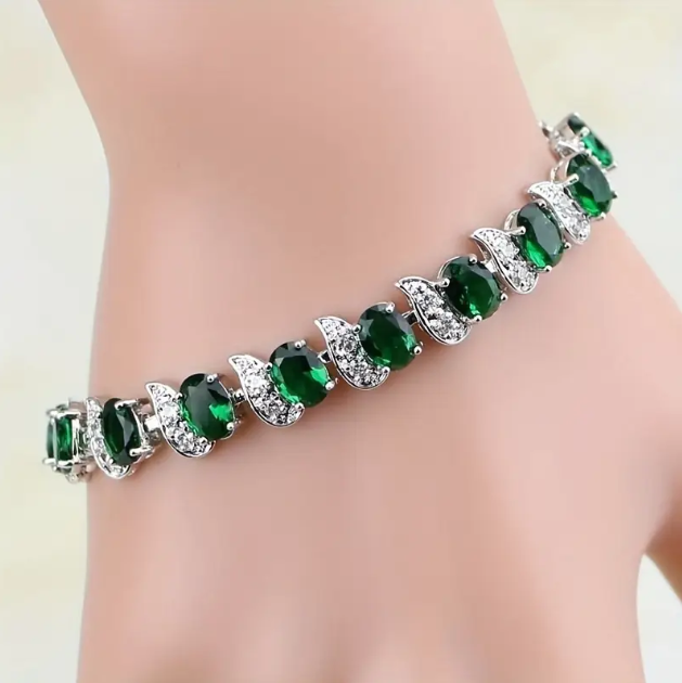 Elevate your style with the Sterling Silver Green Gemstone Cubic Zirconia Adjustable Bracelet, a dazzling and timeless accessory—available now at Mozzimo Jewelry.