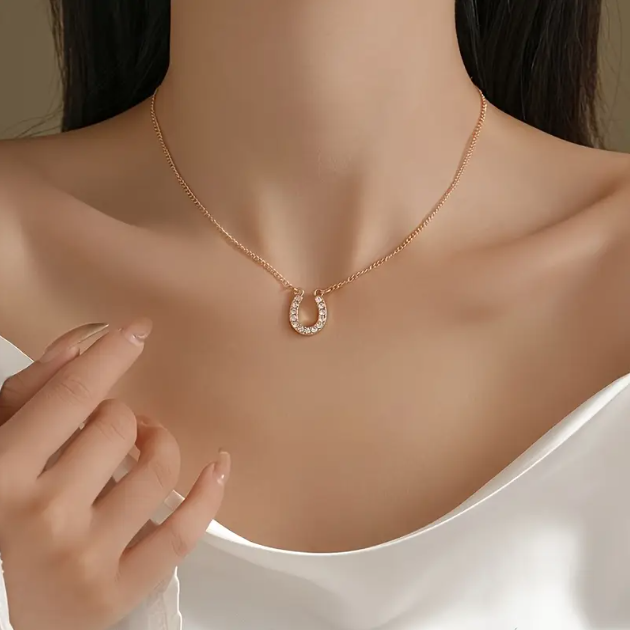 Add a touch of luck and luxury with the Gold Plated Mini White Gemstone Encrusted Horseshoe Pendant Charm Necklace from Mozzimo Jewelry.