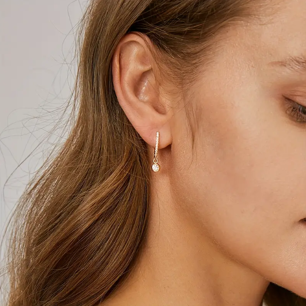 Elegant gold-plated rhinestone mini hoops with white gemstone drops – the perfect balance of sparkle, charm, and modern flair.