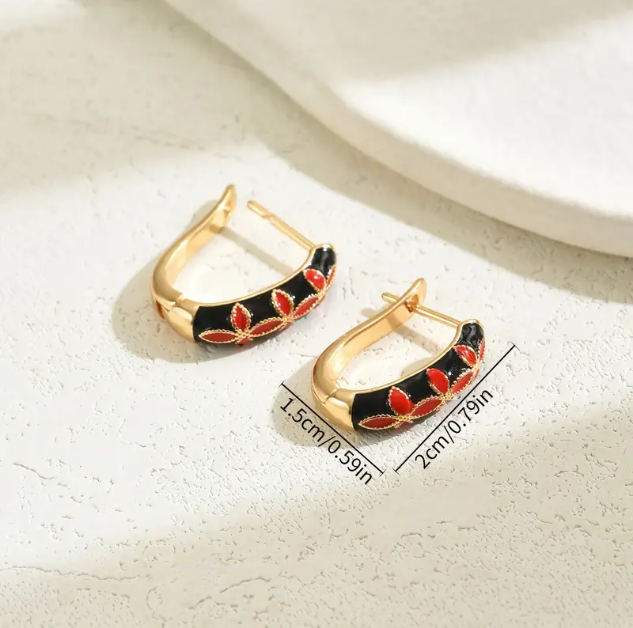 Shop Mozzimo Jewelryβs Gold Plated Floral Enamel Black and White Mini Hoop Earringsβmodern floral design with gold-plated hoops for a chic statementβavailable now at www.mozzimojewelry.com.