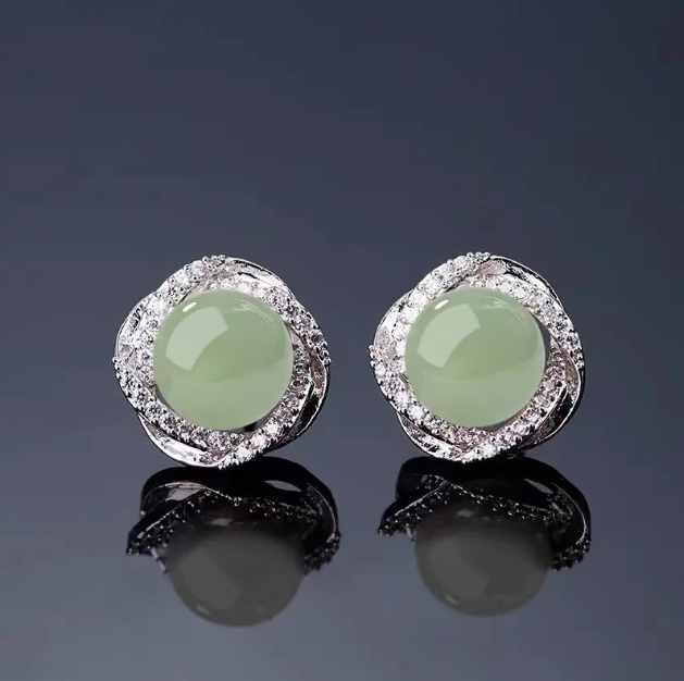 Add elegance to your look with these Sterling Silver Rhinestone Encrusted Circle Jade Earring Studs, a perfect blend of sparkle and sophistication—available now at Mozzimo Jewelry.