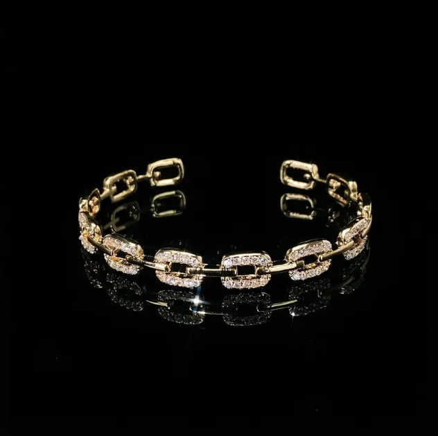 Add a touch of elegance with the Glittery Gold Plated Rhinestone Encrusted Interlocking Cuff Bracelet from Mozzimo Jewelry. Shop now for luxury and timeless beauty.