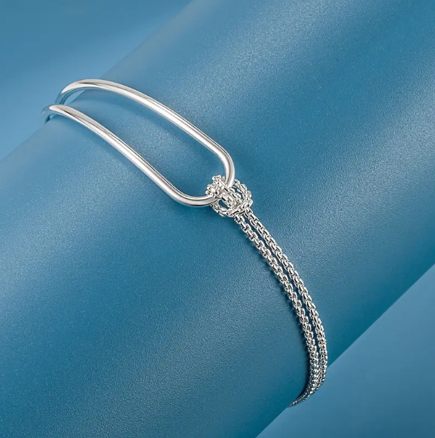 Explore the timeless elegance of the sterling silver fine knot hook clasp bracelet at Mozzimo Jewelry—perfect for adding a refined touch to any outfit.