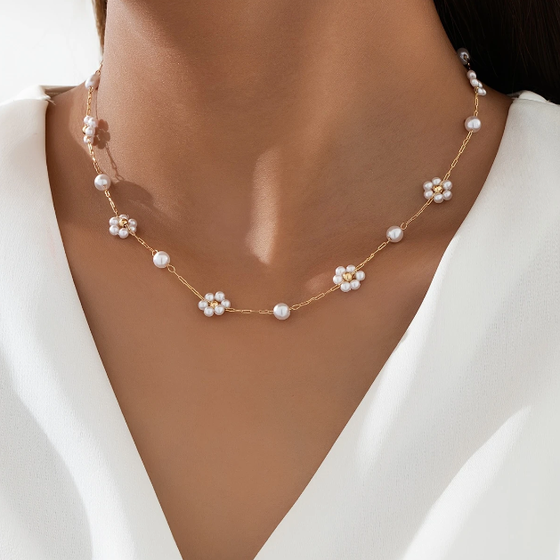 Elegant and dainty, this gold-plated necklace features mini faux pearl flower charms on a fine chain—perfect for layering or solo wear.