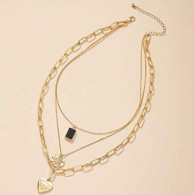 Elevate your style with the Gold Plated 3 Layer Black Enamel Heart Rectangular Pendant and Coin Chain Necklace from Mozzimo Jewelry. Shop now at www.mozzimojewelry.com.