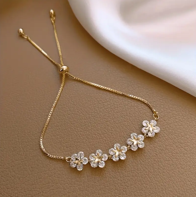 Elevate your jewelry collection with our Gold Plated Rhinestone Encrusted Gemstone Flower Adjustable Chain Bracelet.