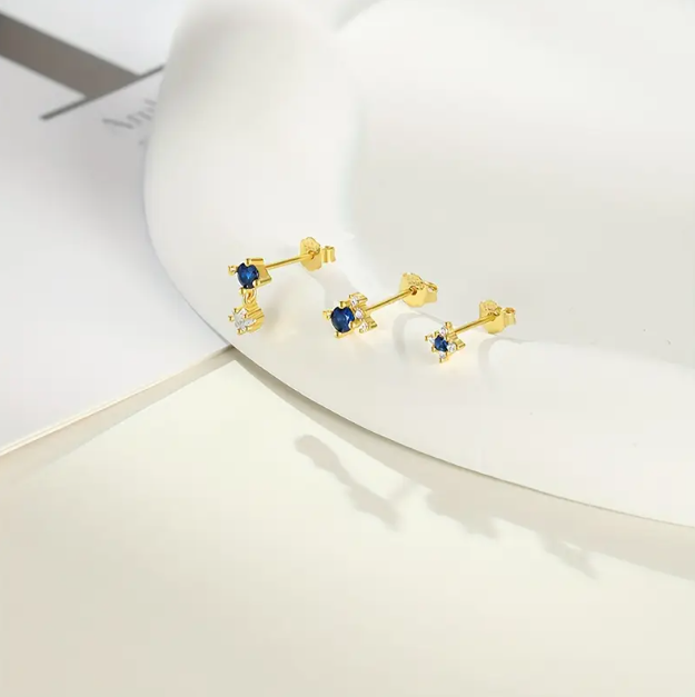 Add a pop of color with Mozzimo Jewelry's 3 Piece Gold Plated Blue Gemstone Cubic Zirconia Studs Set – vibrant, elegant, and perfect for everyday or layered looks.