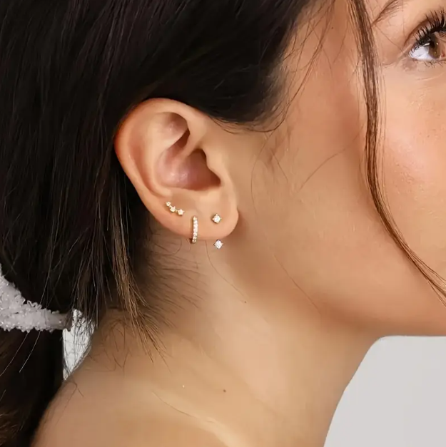 Shine bright with Mozzimo Jewelry's 3 Piece Golden Cubic Zirconia Mini Hoops and Studs Set – versatile, elegant, and perfect for effortless everyday style.
