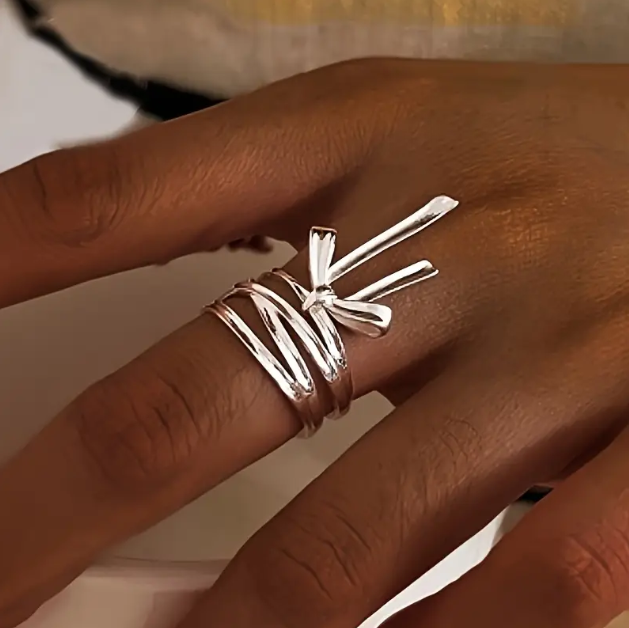 Delicate and elegant, our Sterling Silver Wrapped Ribbon Bow Ring adds a feminine touch to any look with its adjustable fit.