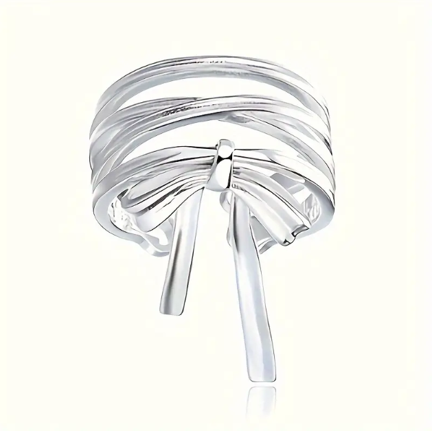 Delicate and elegant, our Sterling Silver Wrapped Ribbon Bow Ring adds a feminine touch to any look with its adjustable fit.