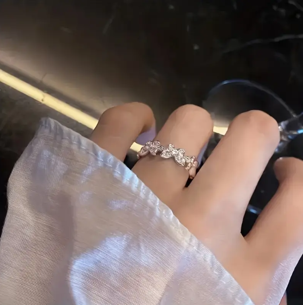Adorn your fingers with the Sterling Silver Rhinestone Encrusted Connected Butterflies Adjustable One Size Ring – a dazzling, delicate piece.