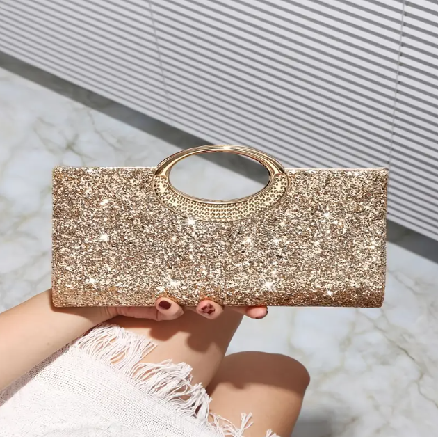 Dazzling sparkly gold rectangular evening clutch. Glamorous accessory for pairing with elegant evening wear. Shop luxury clutches and bags at Mozzimo Jewelry.