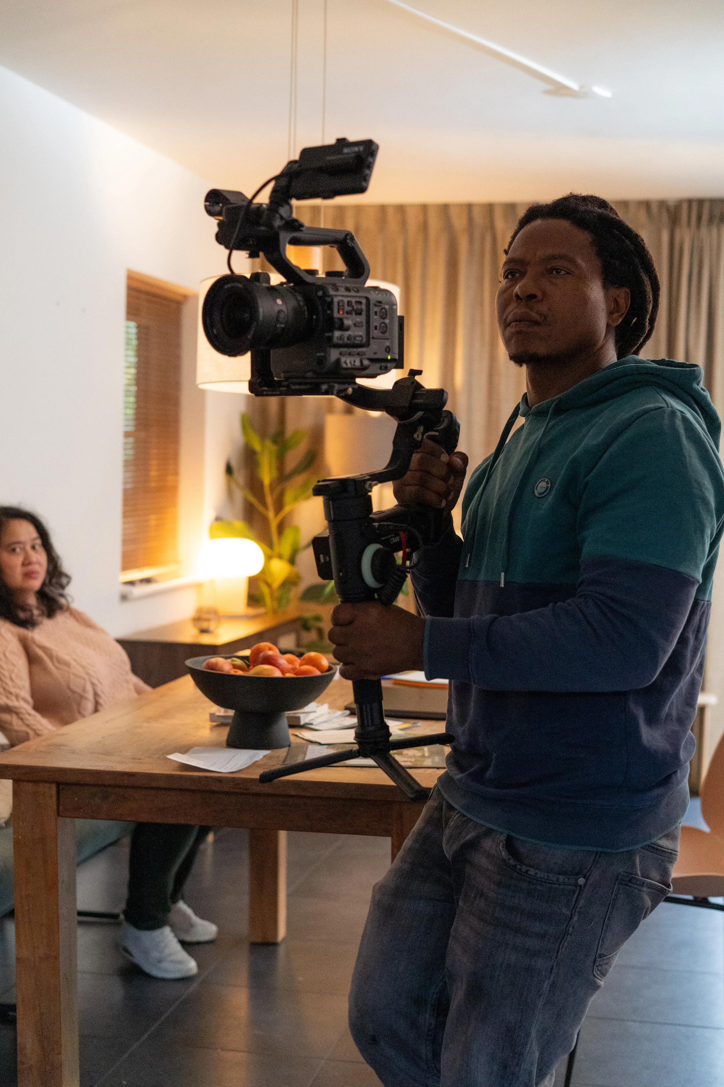 Cinematographer operating gimbal during active film shoot for narrative scene