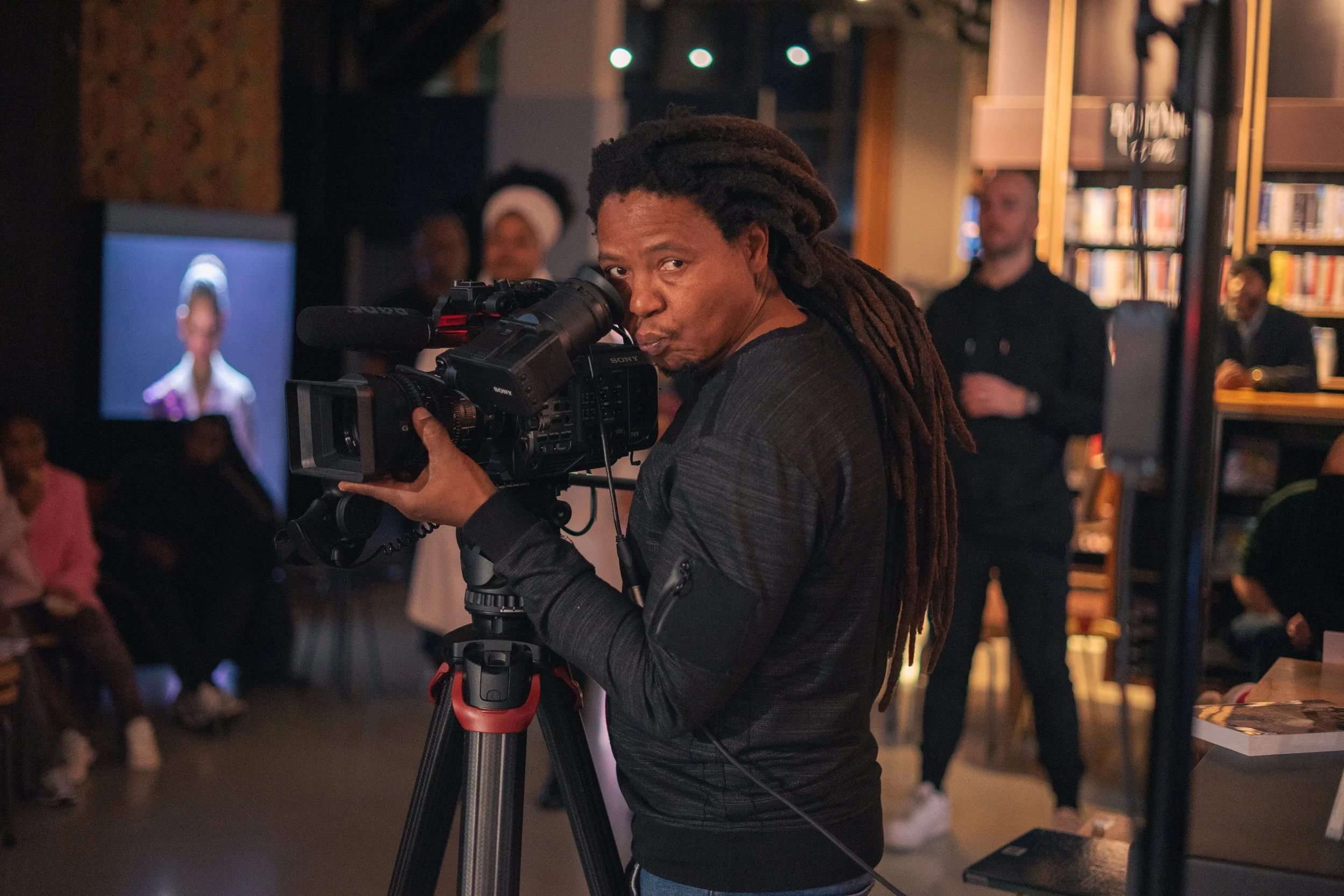 Cinematographer observing stage lighting during live music production in Amsterdam