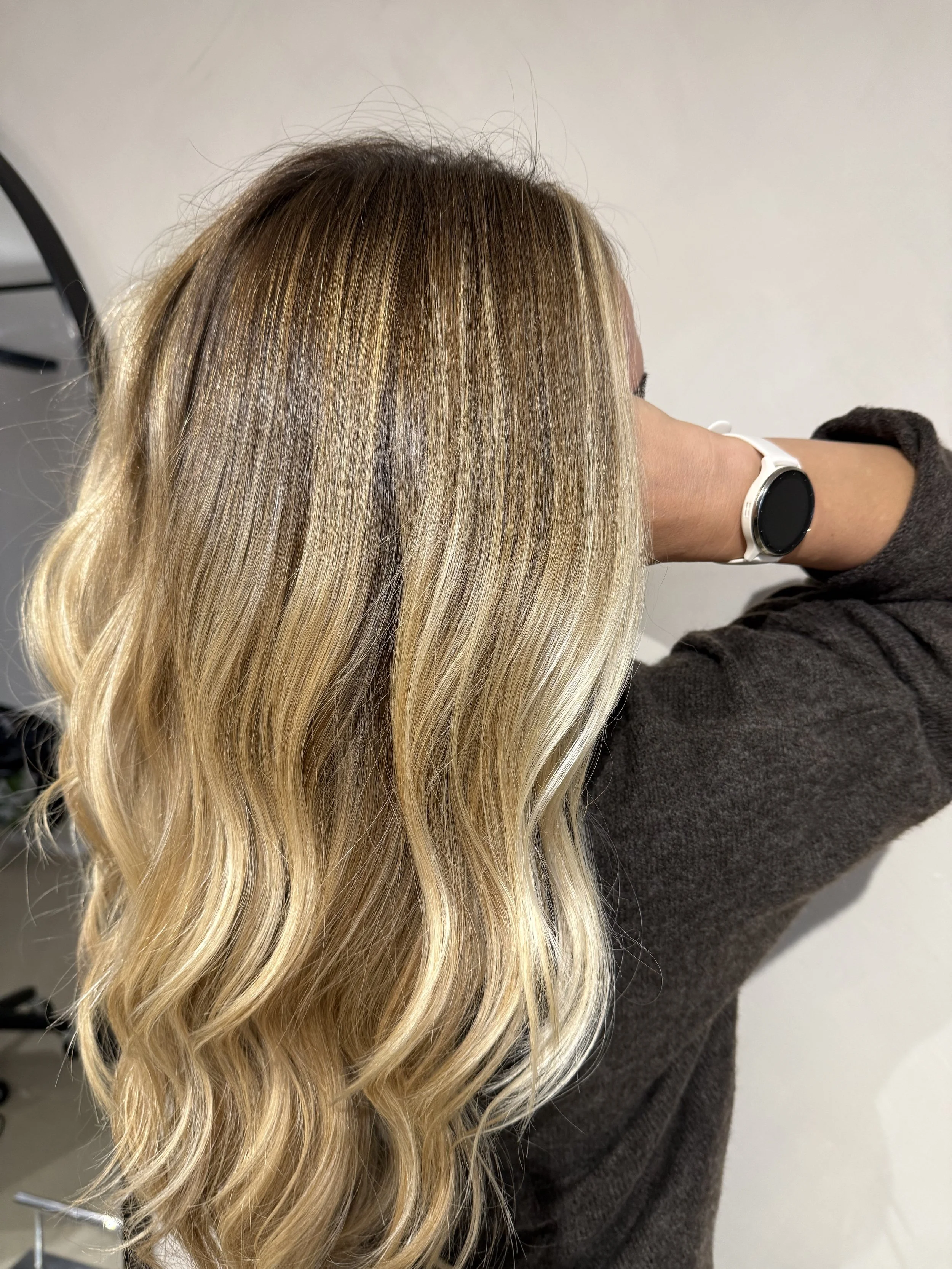 Blonde wavy hair with subtle highlights.