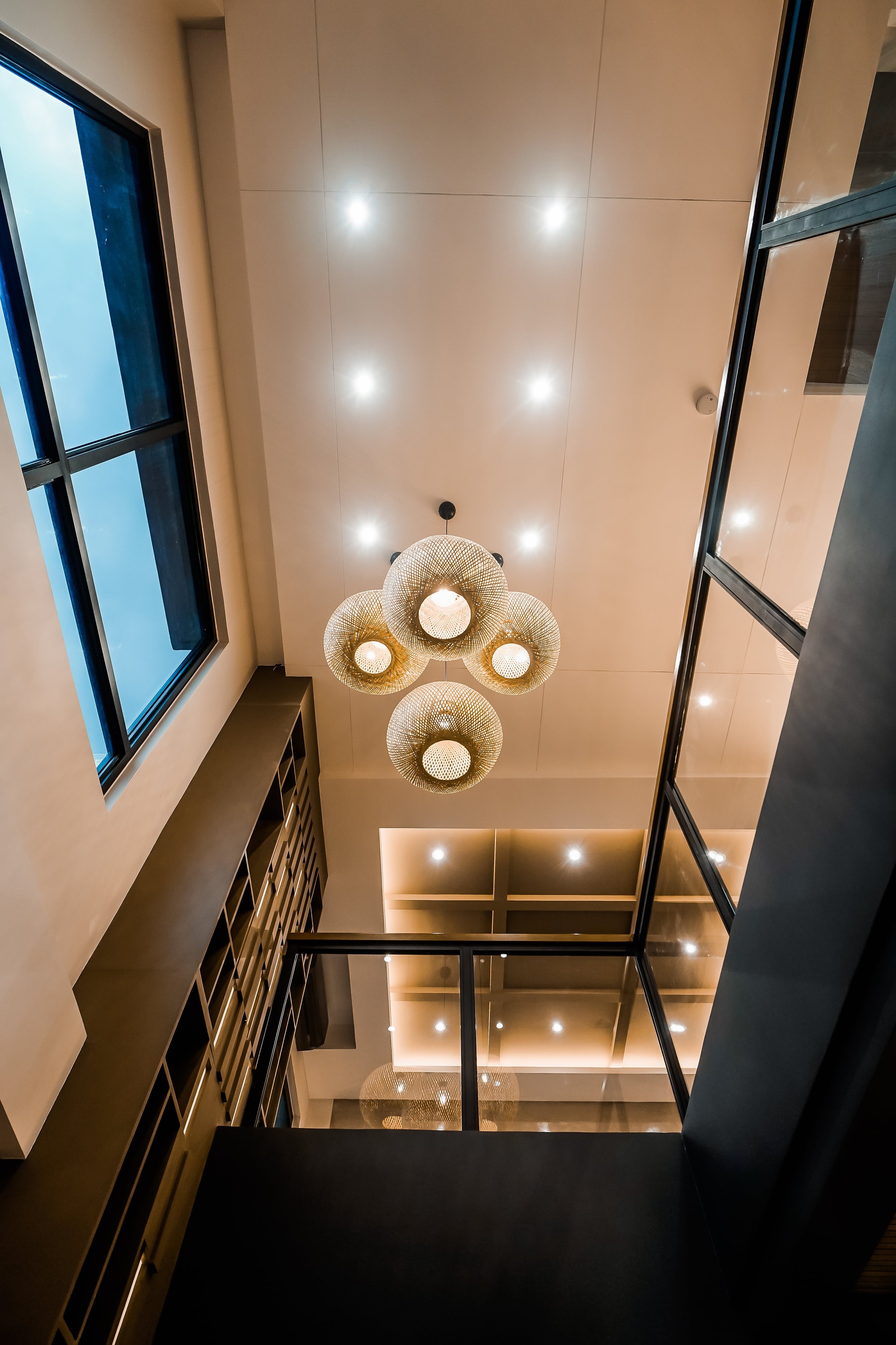 Modern interior with ceiling lights and large windows
