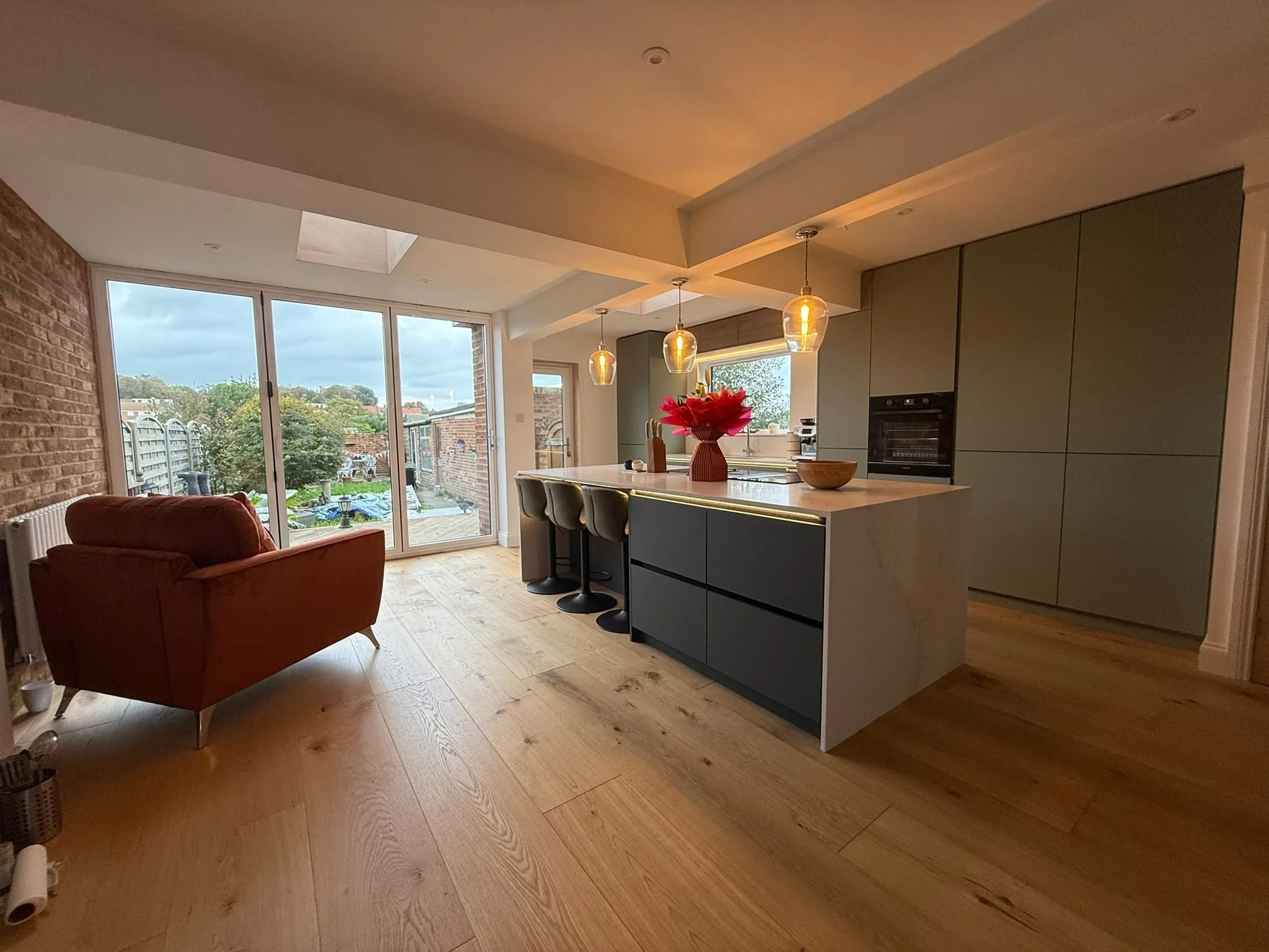 Sage and charcoal kitchen with island designed and fitted by Grover Kitchen & Bathrooms in Worthing