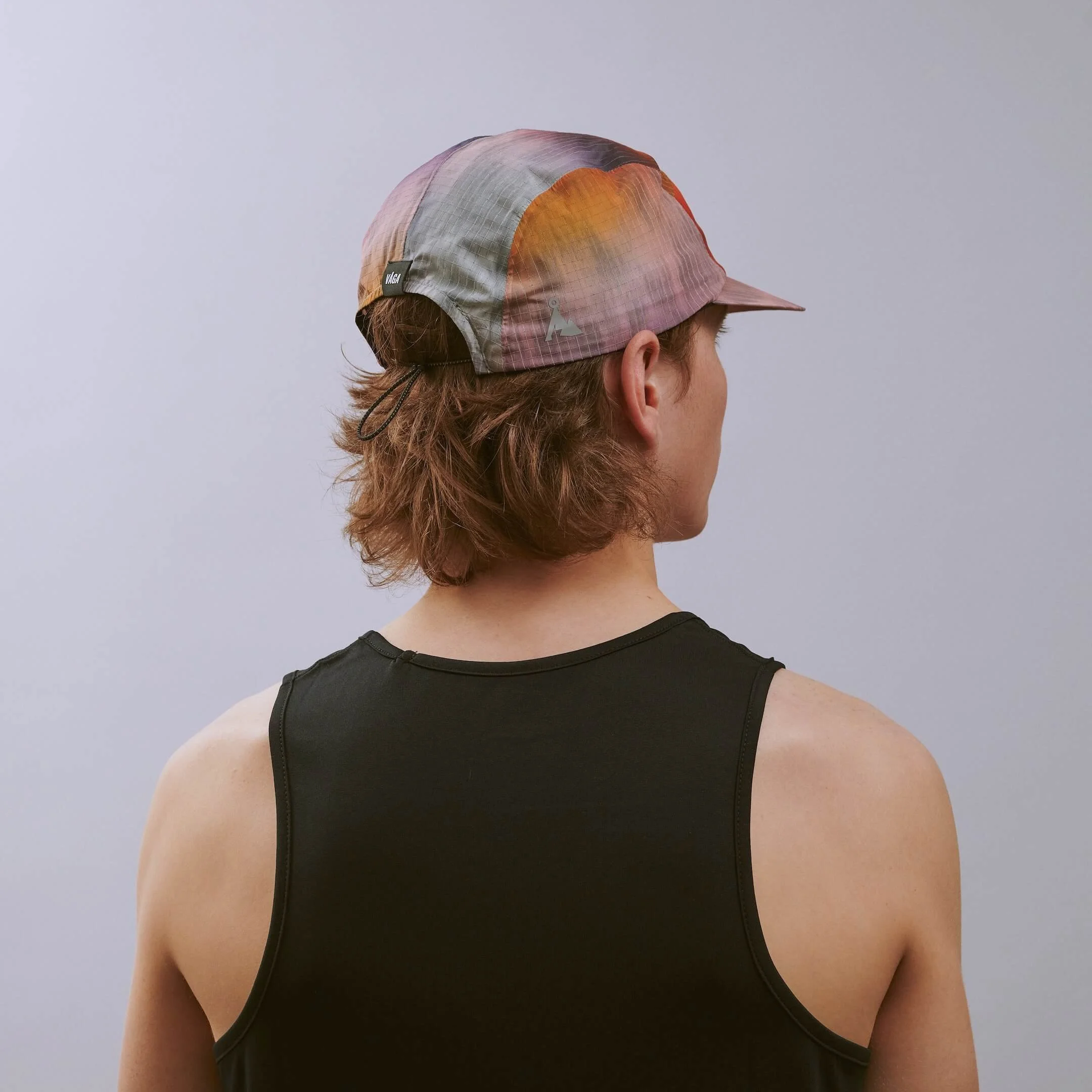 vaga-night-club-reflective-running-cap-sunset-e-model-angle.jpg