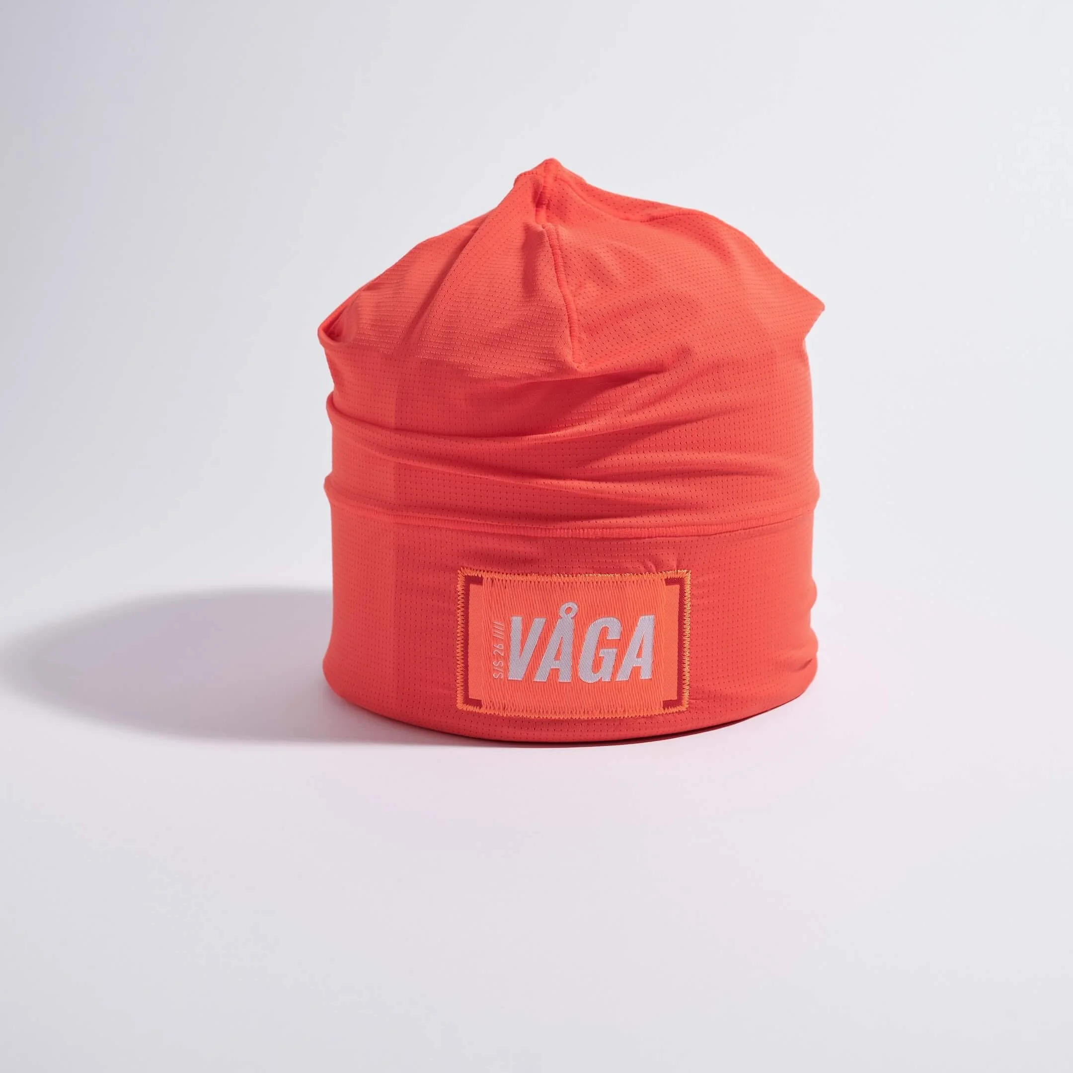 vaga-lightweight-mesh-skull-cap-running-beanie-neonpeach-stood.jpg
