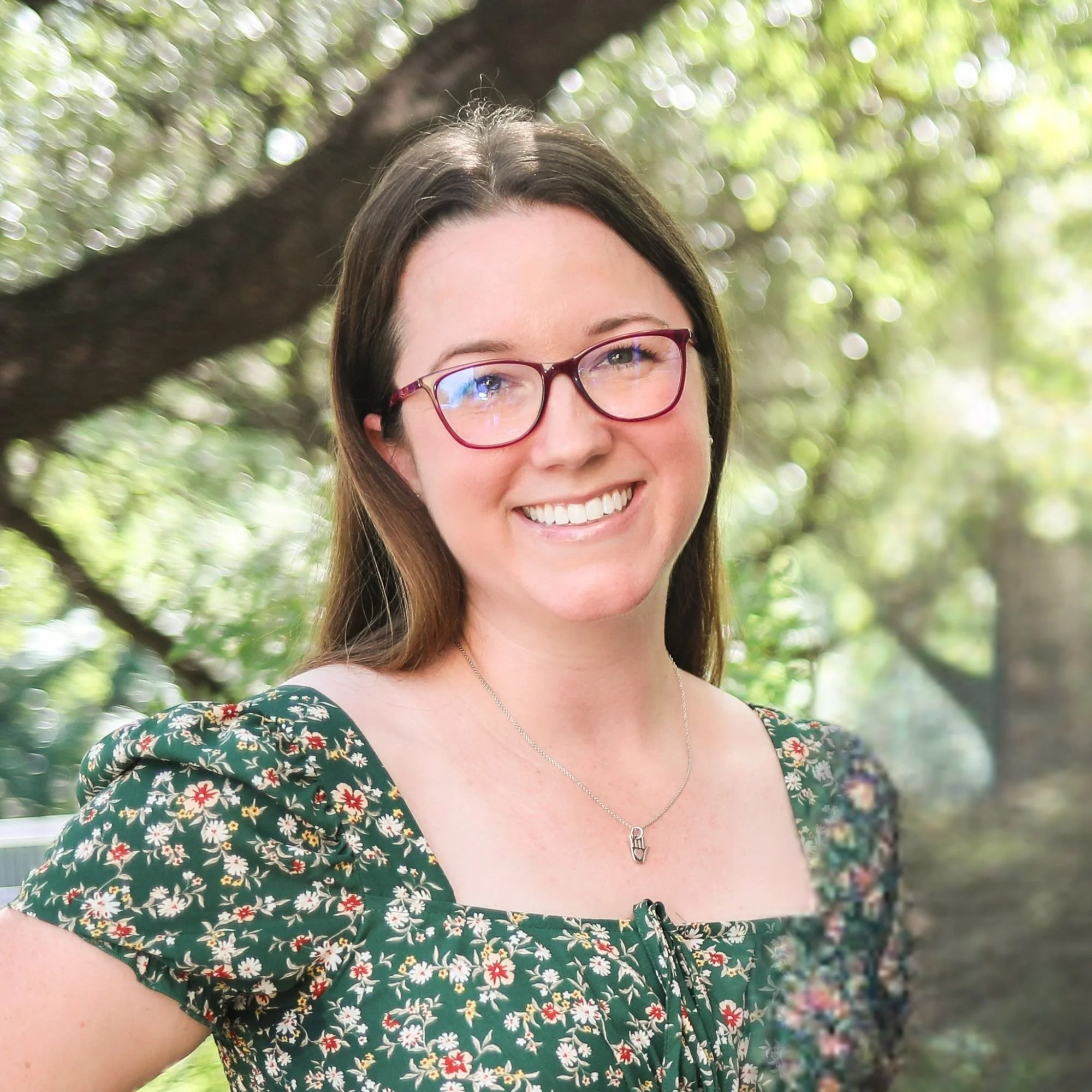 Woman in floral dress smiling 