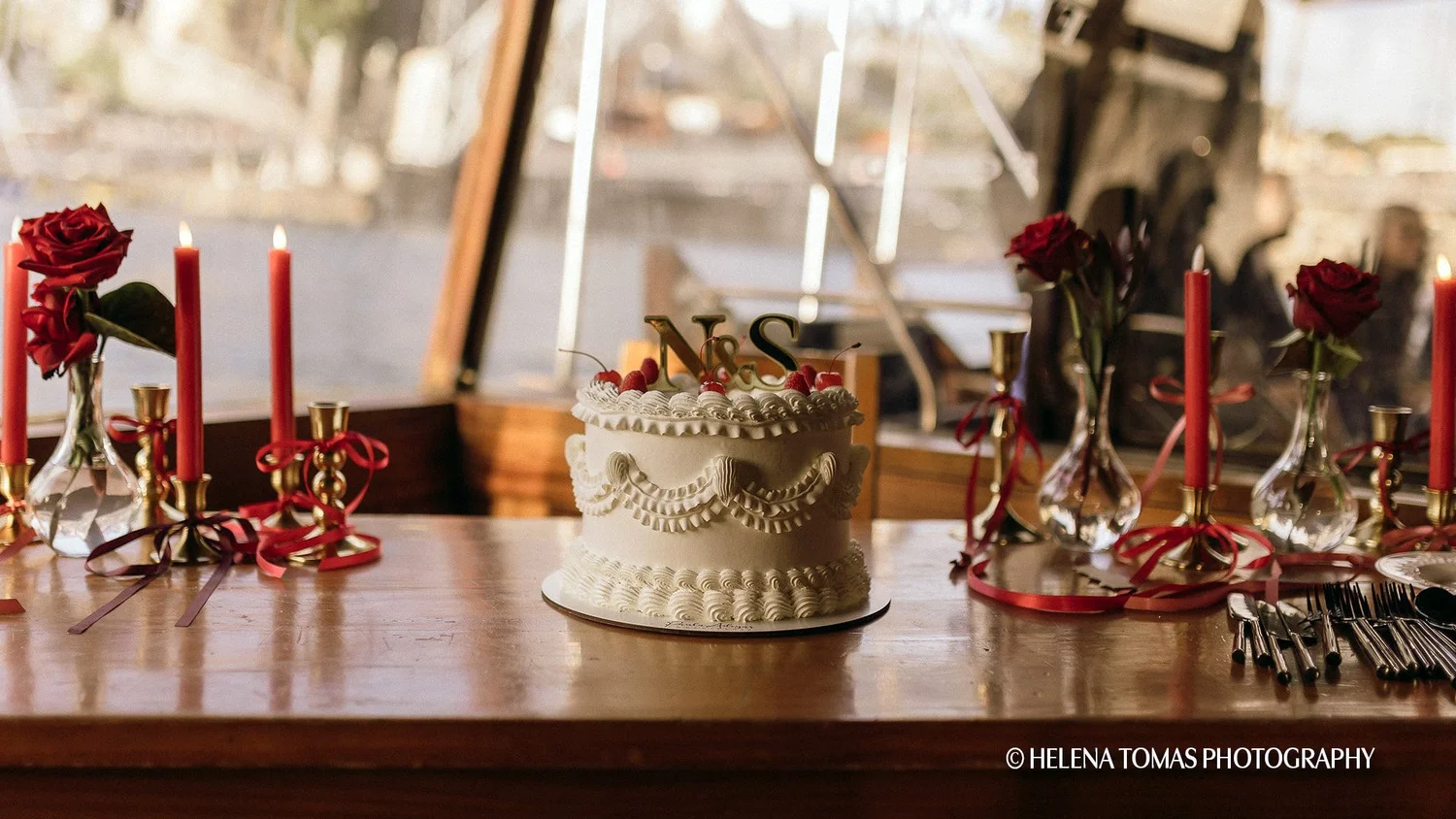 Celebration cake and table setting aboard a private Rabelo boat