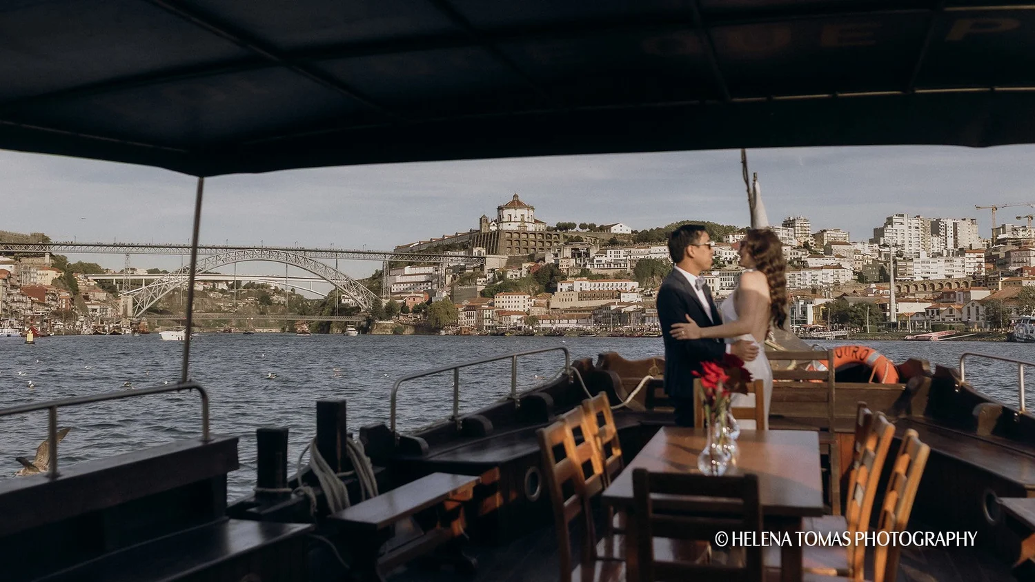 Couple celebrating aboard a private Rabelo boat in Porto