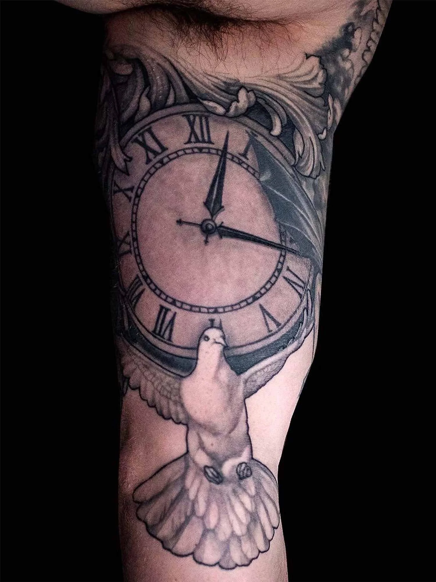  Classic, fine-line tattoo of a beautiful black &amp; grey of a dove and clock on inner arm. 