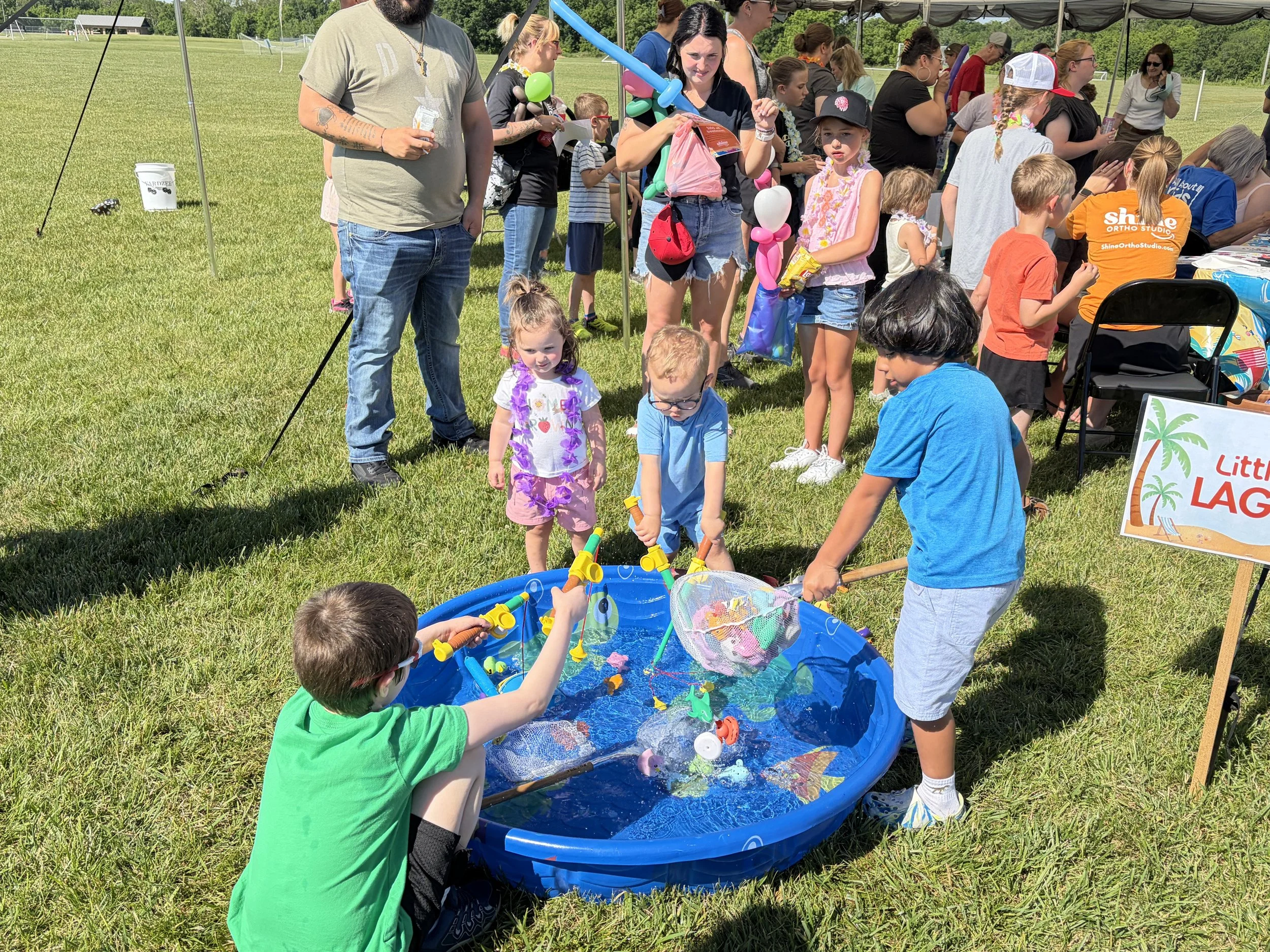Children enjoying outdoor water games at the All About Kids Pediatric Dentistry Family Fun Day in Napoleon, Ohio.