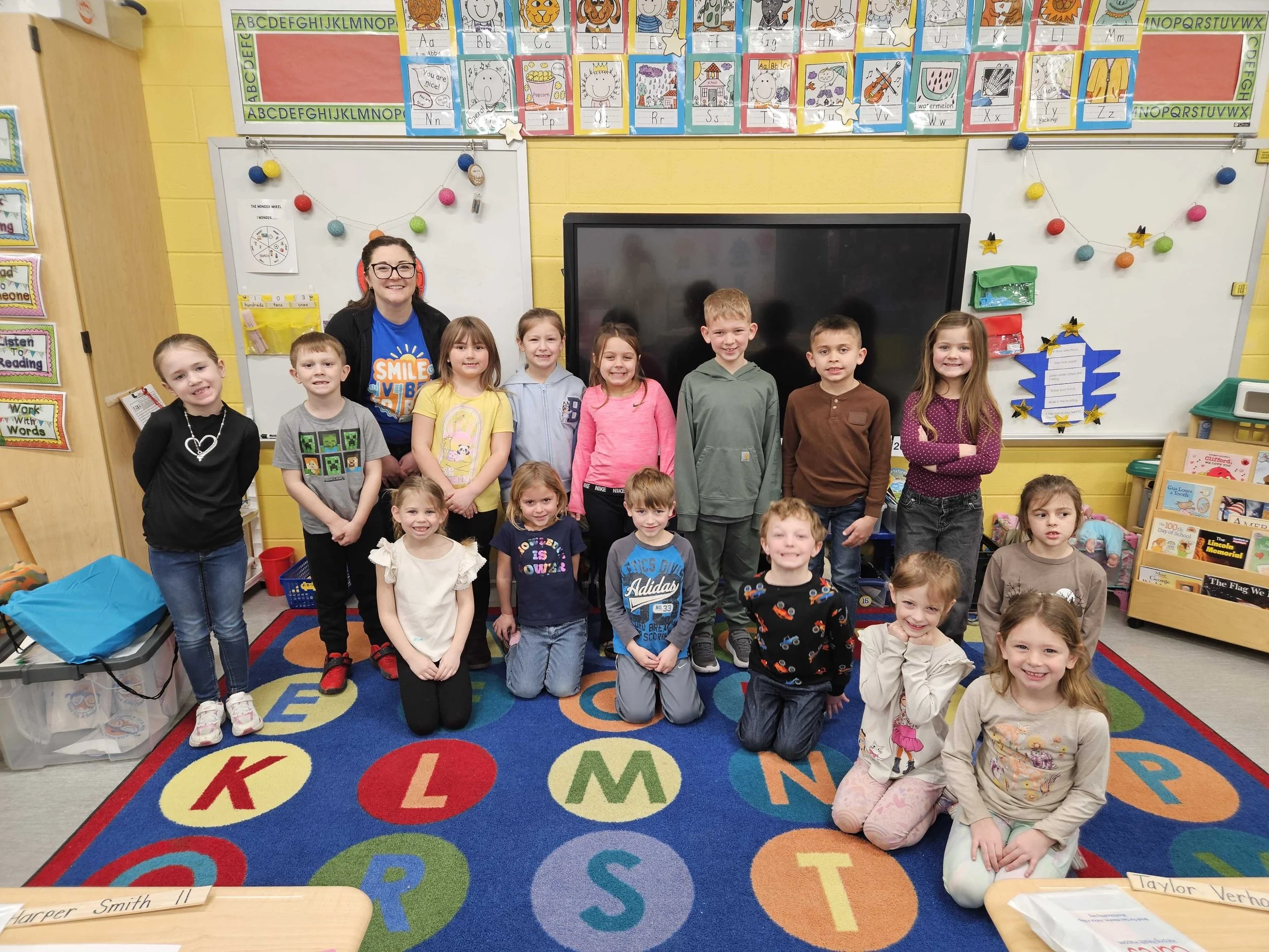 All About Kids Pediatric Dentistry team member posing with elementary school students during a National Children's Dental Health Month school visit in Napoleon, OH