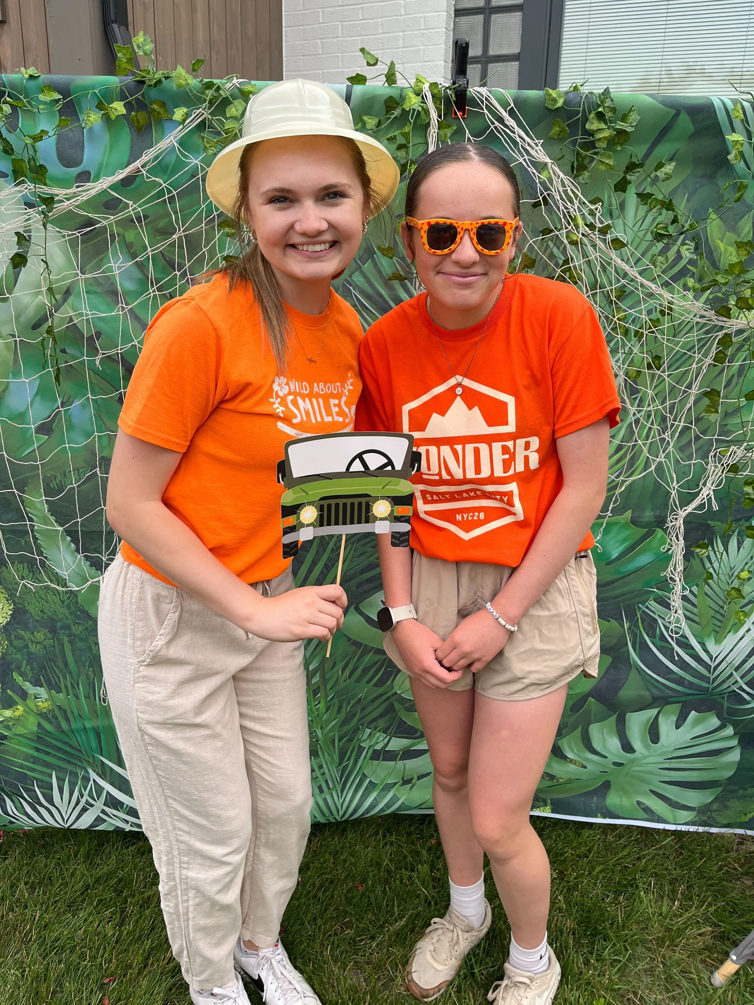 All About Kids Pediatric Dentistry team members smiling at a jungle themed backdrop during the Kids’ Day community event in Napoleon Ohio.